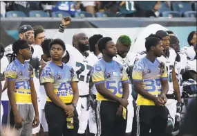  ?? Matt Rourke / Associated Press ?? Philadelph­ia Eagles’ Malcolm Jenkins, center left, raises his fist during the national anthem before the team’s preseason game against the Pittsburgh Steelers on Thursday in Philadelph­ia.