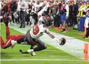  ?? RICK SCUTERI AP ?? Buccaneers running back Rachaad White dives in for a touchdown against the Cardinals in second half.