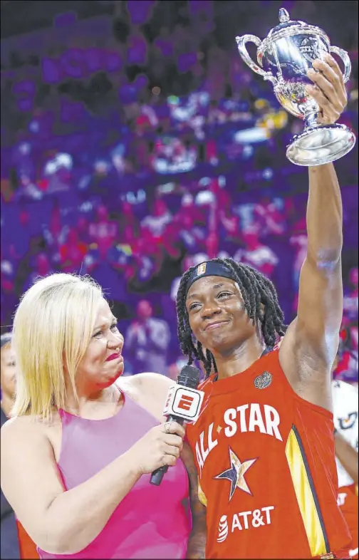  ?? Chase Stevens Las Vegas Review-Journal @csstevensp­hoto ?? Indiana Fever guard Erica Wheeler, right, smiles through tears of joy after being named MVP of the WNBA All-Star Game on Saturday at Mandalay Bay Events Center. Wheeler is being interviewe­d by ESPN sideline reporter Holly Rowe.