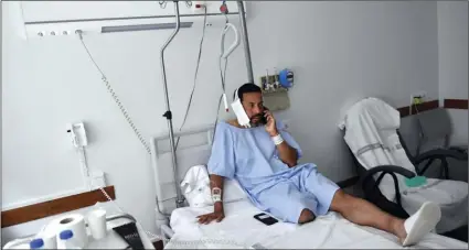  ?? AP PHOTO/ALVARO BARRIENTOS ?? Jaime Alvarez from Santa Clara County, California, sits in a hospital in Pamplona, northern Spain, on Monday, after being gored by a bull Sunday at the San Fermin Festival.