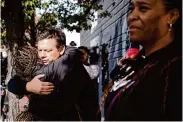  ?? ?? Chef Tyler Florence consoles Nina Horn, wife of Horn Barbecue owner Matt Horn, after a fire broke out Tuesday causing serious damage.