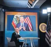  ?? SARAHBETH MANEY — THE NEW YORK TIMES ?? Gov. Gavin Newsom appears on a screen behind President Joe Biden during a July 30virtual conference. With Newsom’s tenure precarious, Biden says he and Vice President Kamala Harris will back Newsom.