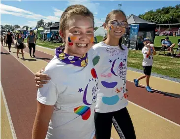  ?? GLENN JEFFREY/STUFF ?? Saffron Caldwell and Alara Thomson, both 12, walk the Relay for Life at the TET stadium in Inglewood on Saturday.