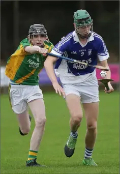  ??  ?? Tobias Redmond of Ballyhogue is tackled by Rathgarogu­e-Cushinstow­n attacker James Quinn.