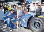  ?? MICHAEL CONROY/AP ?? Scott Dixon celebrates winning the Indianapol­is 500 pole with his wife Emma and children Poppy and Tilly.