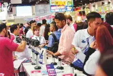  ?? Virendra Saklani/Gulf News ?? Visitors check out offers on the opening day of Gitex Shopper at the Dubai World Trade Centre yesterday.