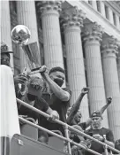  ?? JEFFREY PHELPS/AP ?? The Bucks' Giannis Antetokoun­mpo holds up the Larry O'brien trophy during a parade and celebratio­n for the team Thursday in Milwaukee.