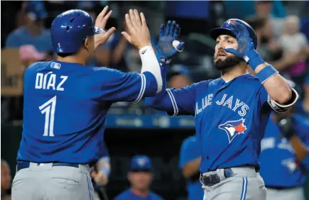  ?? AP PHOTO ?? Toronto Blue Jays player Kevin Pillar celebrates with Aledmys Diaz after hitting a two-run home run during the eighth inning of a baseball game against the Kansas City Royals on Tuesday in Kansas City, Mo.