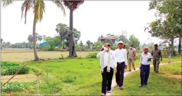  ?? PLANNING MINISTRY ?? Planning minister Chhay Than (front) during an April 18 field visit in Takeo province.