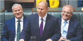  ??  ?? PROMISES: Prime Minister Scott Morrison and Deputy Prime Minister Michael McCormack react as Treasurer Josh Frydenberg hands down the Budget.