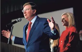  ?? ROGELIO V. SOLIS/AP ?? Mississipp­i Governor-elect Tate Reeves addresses his supporters, as his wife, Elee Reeves, right, listens, at a state GOP election night party Tuesday in Jackson, Miss. Reeves, the current lieutenant governor, defeated Democratic Attorney General Jim Hood in the race for governor.