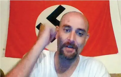  ??  ?? Full of hate: Posing with a Nazi flag, a man called ‘Jermania’ praises the Finsbury Park attack in a video on YouTube