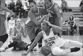  ?? SARAH GORDON/THE DAY ?? New London’s Xaryia Melendez (34) reacts to a call after battling with three Norwich Free Academy defenders during Wednesday night’s Eastern Connecticu­t Conference Division I girls’ basketball tournament championsh­ip game at Plainfield. The top-seeded...