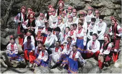 ?? ?? Members of the Tavria School of Ukrainian Dance gather for a group photo on the rocks next to the Crescent Park amphitheat­re.