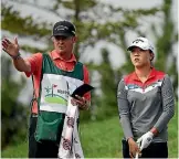  ??  ?? Caddie Jason Hamilton gives advice to Lydia Ko during their final tournament together in Korea.