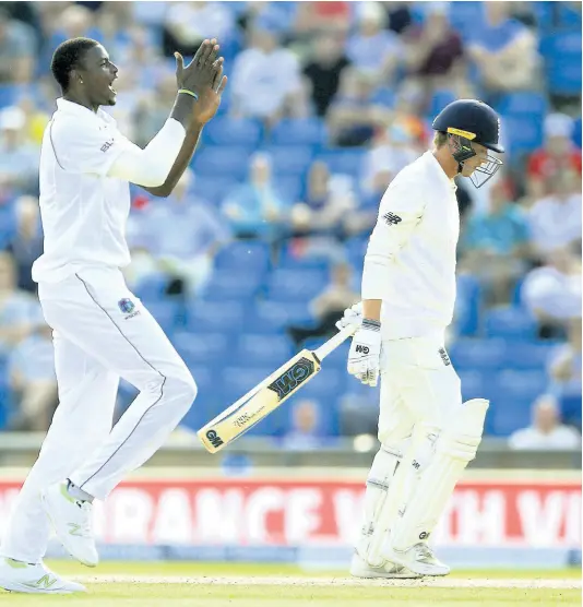  ?? AP ?? West Indies’ Jason Holder celebrates after taking the wicket of England’s Tom Westley during day three of the second cricket Test match at Headingley, Leeds, England, Sunday, August 27, 2017.