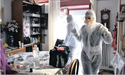  ?? |
AP ?? PRECAUTION
MEDICAL staffers wearing protective gear, part of a special unit performing house calls, work in Bergamo, northern Italy, one of the areas worse-affected by the coronaviru­s, yesterday.