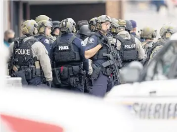  ?? DAVID ZALUBOWSKI/AP ?? Police outside a King Soopers grocery store where a shooting took place Monday in Boulder, Colo.