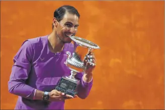  ?? REUTERS ?? Spain’s Rafael Nadal celebrates with the trophy after beating Serbia’s Novak Djokovic 7-5, 1-6, 6-3 in Sunday’s final in Rome to claim his 10th Italian Open title.