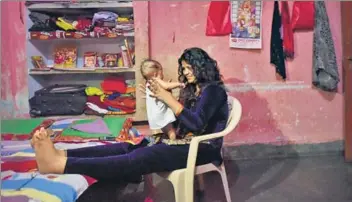  ??  ?? Right: Dancers Naina Sharma and Shobha Sigdha share a light moment at their apartment in Patna. Below: Guests watching a live dance performanc­e at a litup canopy on the outskirts of Ara, Bihar.