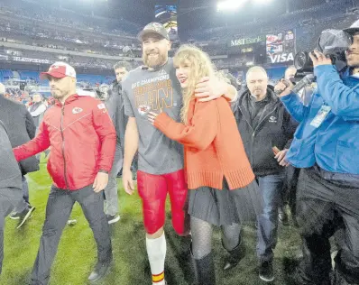  ?? AP ?? Kansas City Chiefs tight end Travis Kelce walks with Taylor Swift following the AFC Championsh­ip NFL football game between the Baltimore Ravens and the Kansas City Chiefs in Baltimore on January 28.