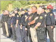  ?? Submitted Photo ?? Members of Gravette and area police and fire department­s stand at attention during the Sept. 11, 2021, remembranc­e ceremony.