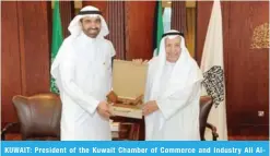  ?? — KUNA photos ?? KUWAIT: President of the Kuwait Chamber of Commerce and Industry Ali AlGhanem (right) presents a gift to Chairman of the Council of Saudi Chambers Ahmad Al-Rajhi.