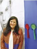  ??  ?? Haifa Abdul Mughni in front of her award winning textile artwork, a quilt she created to honor her father.