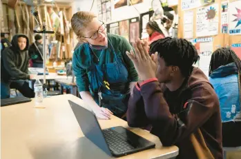  ?? MATT ROURKE/AP ?? Art teacher Alyce Grunt speaks with a student at Penn Wood High School in Lansdowne, Pa., last week as schools across the country struggle to find teachers to hire. Many governors are seeking pay increases and bonuses for teachers.