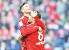  ??  ?? James Rodriguez and Javi Martinez celebrate the goal that took them level on points with Borussia Dortmund. - AFP photo