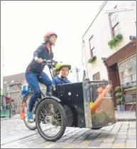  ??  ?? Kristin Fredrickss­on and her daughter Pansy on her cargo bike