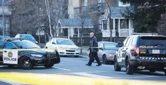  ?? JEFF MCINTOSH/THE CANADIAN PRESS ?? Alberta Serious Incident Response Team investigat­ors and Calgary Police Services attend the scene of a police involved shooting in Calgary in November 2016.