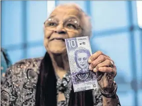  ?? FILE PHOTO ?? Wanda Robson holds a copy of the new $10 bill with her sister Viola Desmond’s picture on it