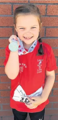  ??  ?? ●●Emilie Austin with one of her four medals