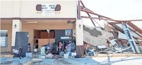  ?? GREGG PACHKOWSKI/USA TODAY NETWORK ?? Bobbie Amaya, who lost her mobile home during Hurricane Michael, camps in her minivan outside her friend’s vape shop in Panama City, Fla.