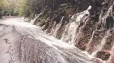  ??  ?? TORRENT: Run-off water pours down roads on kunanyi/ Mt Wellington.