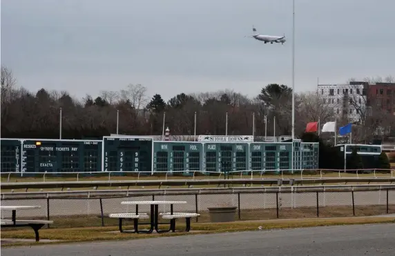  ?? CHRIS CHRISTO PHOTOS / HERALD STAFF FILE ?? MAJOR DEVELOPMEN­T: An airliner comes in to land over Suffolk Downs in Eastie, also seen below, where a massive building project is about to begin. Officials say more needs to be done citywide to provide housing that Bostonians can afford.