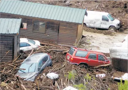  ?? Mike Eliason Santa Barbara County Fire Department ?? FLOODING IN the burn area of last summer’s Sherpa fire in Santa Barbara swept away cabins in El Capitan Canyon on Friday.