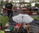  ?? The Associated Press ?? Central American children travelling with a caravan of thousands of migrants rest on a plastic tarp as their parents set up camp in a public park in Huixtla, Mexico.