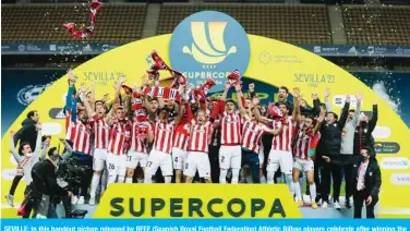  ?? — AFP ?? SEVILLE: In this handout picture released by RFEF (Spanish Royal Football Federation) Athletic Bilbao players celebrate after winning the Spanish Super Cup final football match between FC Barcelona and Athletic Club Bilbao at La Cartuja stadium in Seville on Sunday.