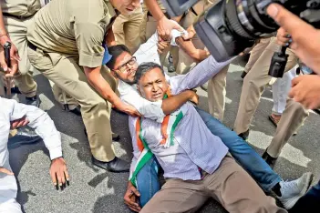  ?? — PTI ?? Congress leader Udit Raj and activists being detained during a protest against summoning of party leader Rahul Gandhi in the National Herald case, near ED office in New Delhi, on Monday.