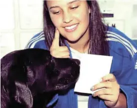  ?? NTSIKELELO QOYO Picture: ?? DOMO ARIGATOU GOZAIMASU: Anje Strydom and her dog taking a photo for the Internatio­nal Judo Federation White Card campaign. This year Strydom qualified for a shodan, the first level black belt in judo