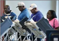  ?? AP/The Augusta Chronicle/MICHAEL HOLAHAN ?? Residents in Augusta, Ga., cast their ballots at the municipal building on Monday, the state’s first day of early voting for the midterm elections.