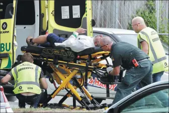  ?? MARK BAKER / ASSOCIATED PRESS ?? Ambulance staff take a man from outside a mosque in Christchur­ch, New Zealand, on Friday. Many people were killed in mass shootings at two mosques in the city.