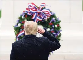 ?? Patrick Semansky / Associated Press ?? President Donald Trump salutes as he participat­es in a Veterans Day wreath laying ceremony at the Tomb of the Unknowns at Arlington National Cemetery in Arlington, Va., on Wednesday.