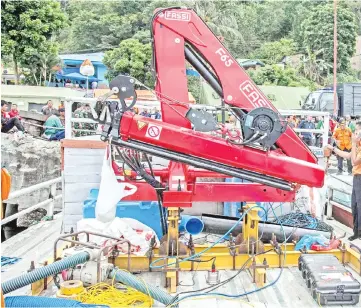  ??  ?? Members of the Indonesian rescue team prepare to deploy sonar equipment to help search for missing passengers at the Lake Toba ferry port in the province of North Sumatra. — AFP photo