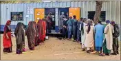  ?? PTI ?? In this undated photo, voters wait in queues to cast their votes at a polling station set up in a shipping container, in Bharuch, Gujarat