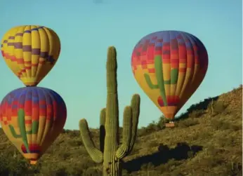  ?? HOT AIR EXPEDITION­S ?? Hot-air balloons take flight over the Saguaro Desert in Arizona.