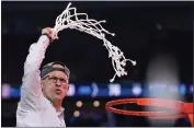  ?? BRYNN ANDERSON — THE ASSOCIATED PRESS ?? Connecticu­t head coach Dan Hurley celebrates during the net cutting after the men’s national championsh­ip game against San Diego State on Monday in Houston.