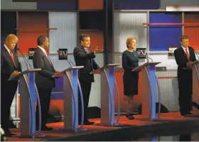  ?? Morry Gash / Associated Press ?? Ted Cruz (center) gestures as Donald Trump (left), Ben Carson, Carly Fiorina and Rand Paul wait their turn during the latest Republican candidates’ debate.